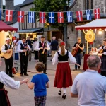 Community celebrating Breton culture at the festival featuring m98 true wallet artisans and musicians.